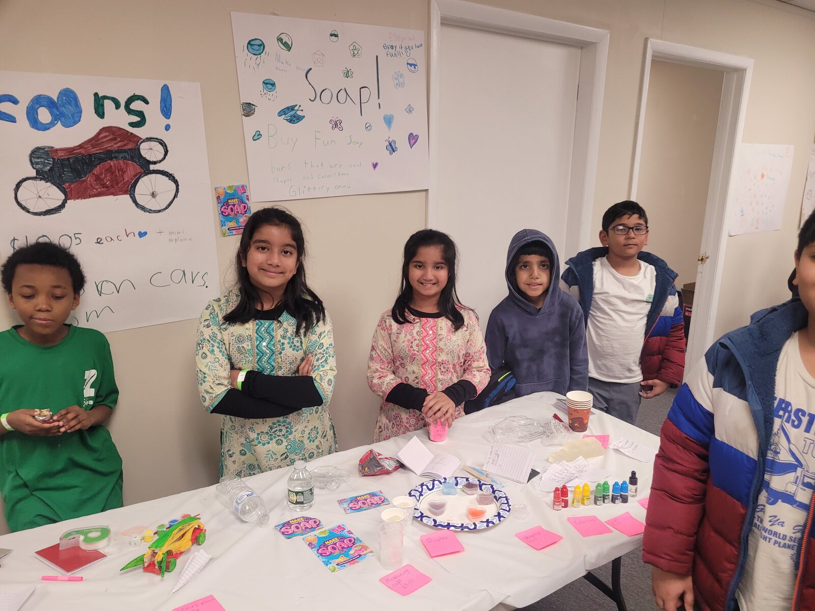 Young participants displaying projects and prototypes at a hands-on entrepreneurship table