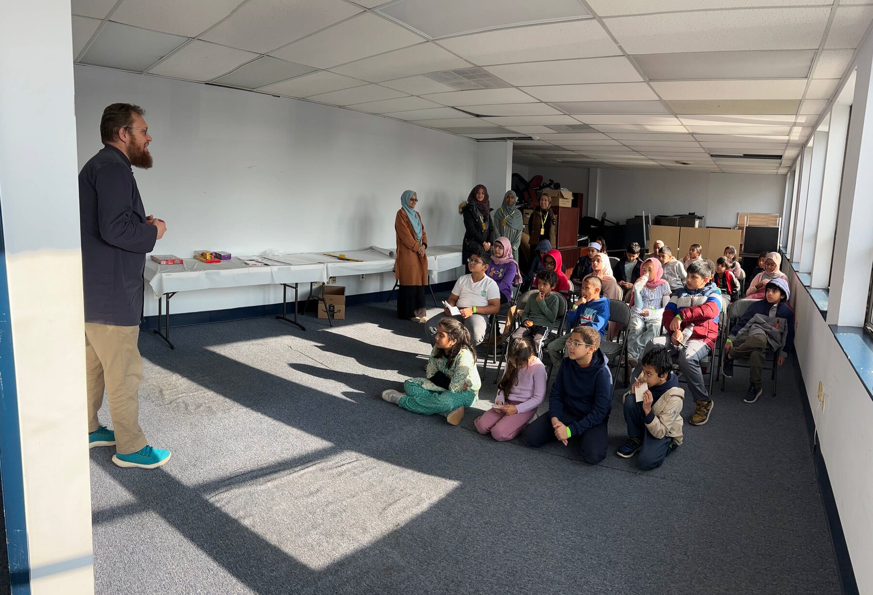 A young participant presenting to a room of peers and mentors